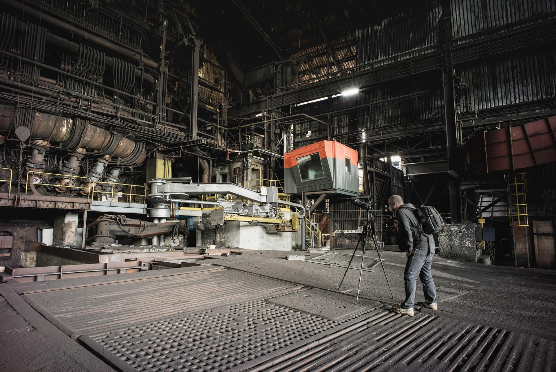 Photographer Matt Emmett preparing a shot in an abandoned factory